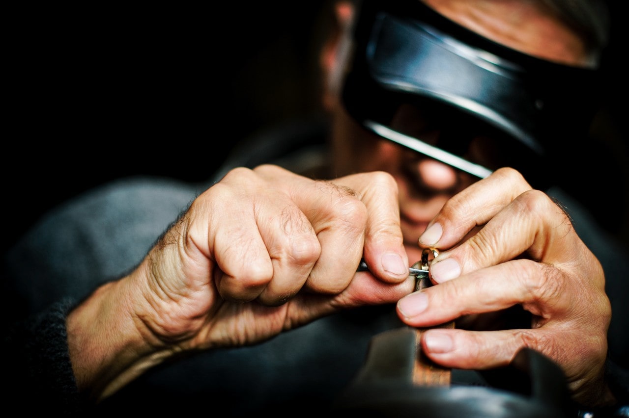 man servicing a jewelry piece