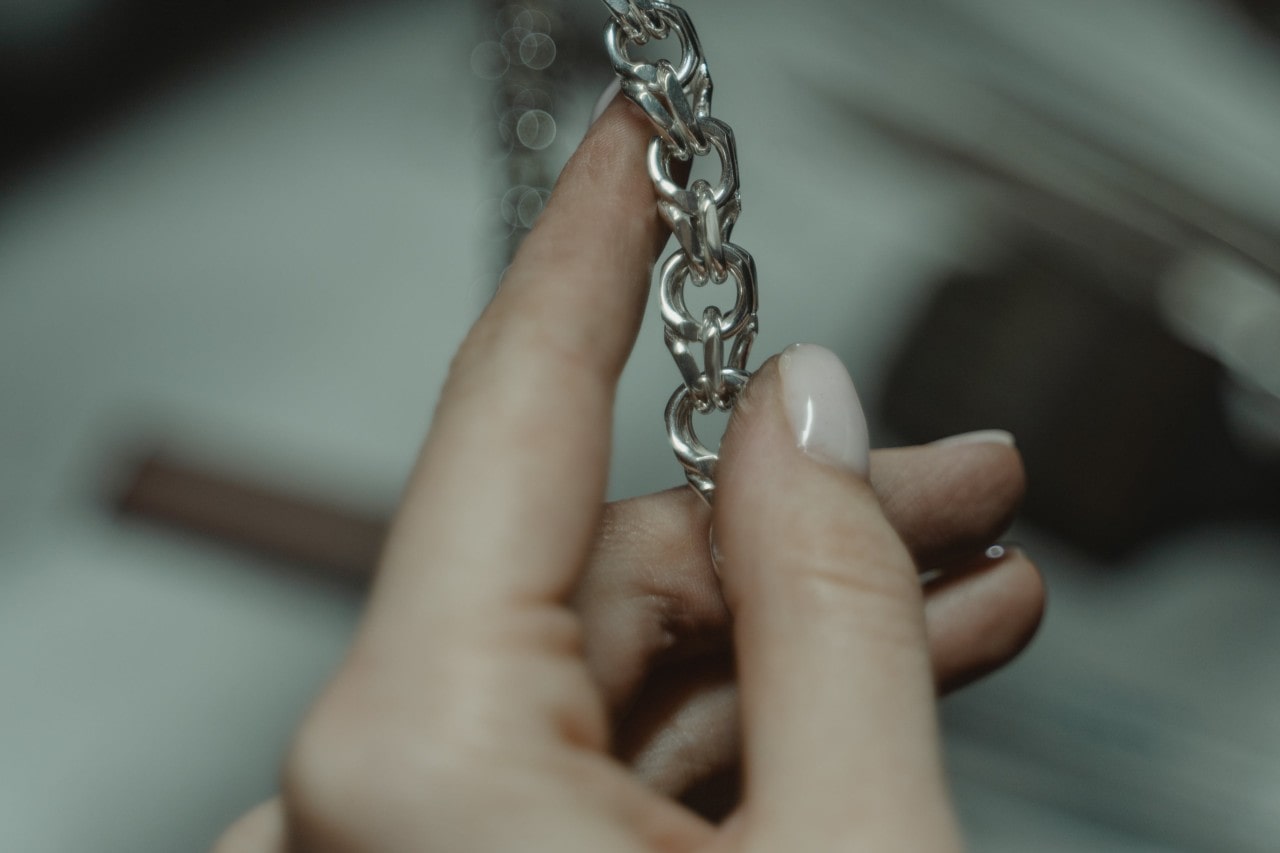 holding chain of  necklace