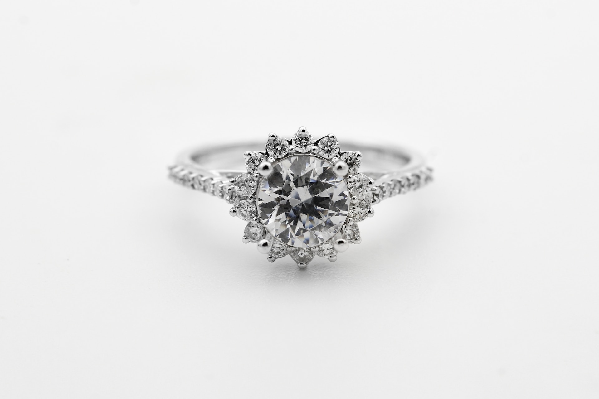 An opulent diamond engagement ring with a distinctive sun-shaped motif.