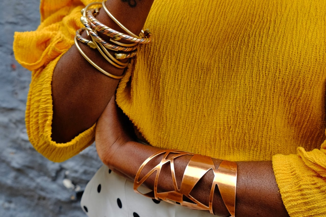 a lady wearing gold bracelets