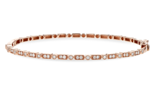 A pink gold bangle from Allison Kauffman, available at Pucci’s Jewelers.