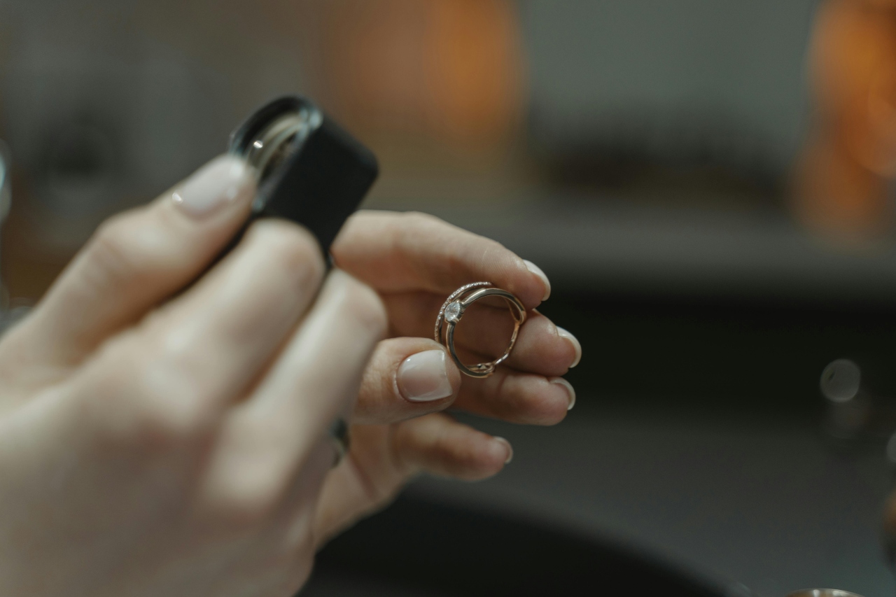 A jeweler examining the diamond they have set into an engagement ring.